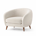 Sillón de tela bouclé beige con patas de madera